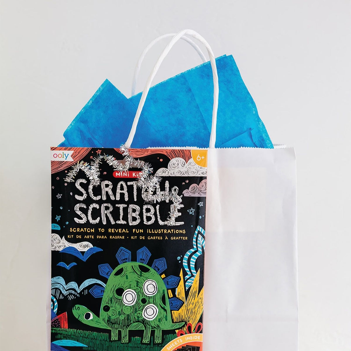 Packaging for Mini Scratch &amp; Scribble Art Kit with illustrations of colorful dinosaurs and scratch-off areas.