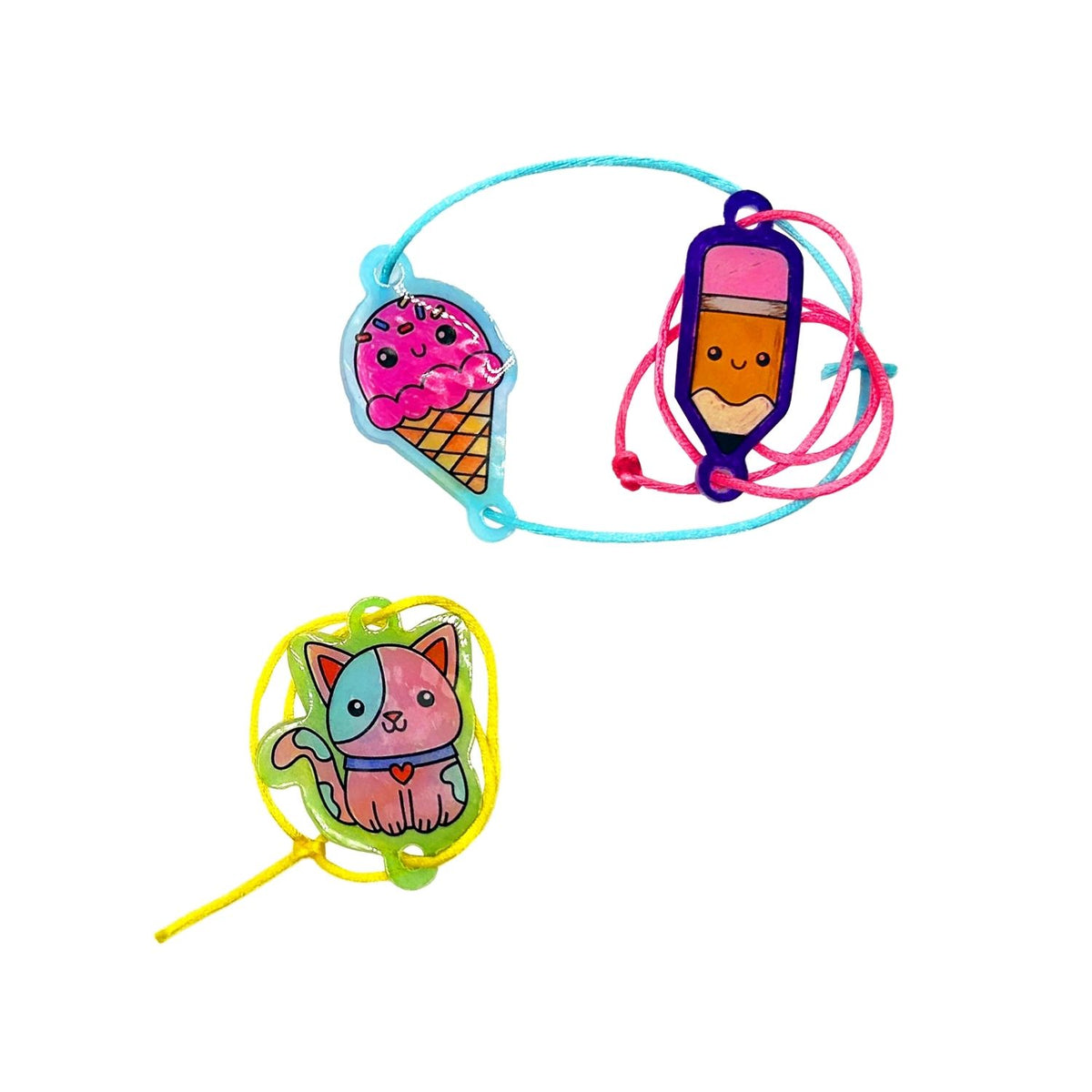Packaging for &#39;Shrink-Its! DIY Shrink Art Bracelet Kit&#39; featuring illustrations of colored charms and hands creating bracelets, with product information and branding.