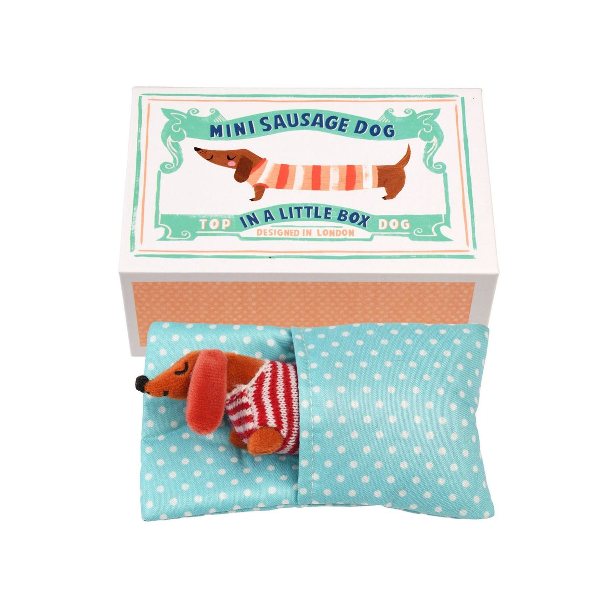 Miniature sausage dog toy in a box with a decorative label on a white background