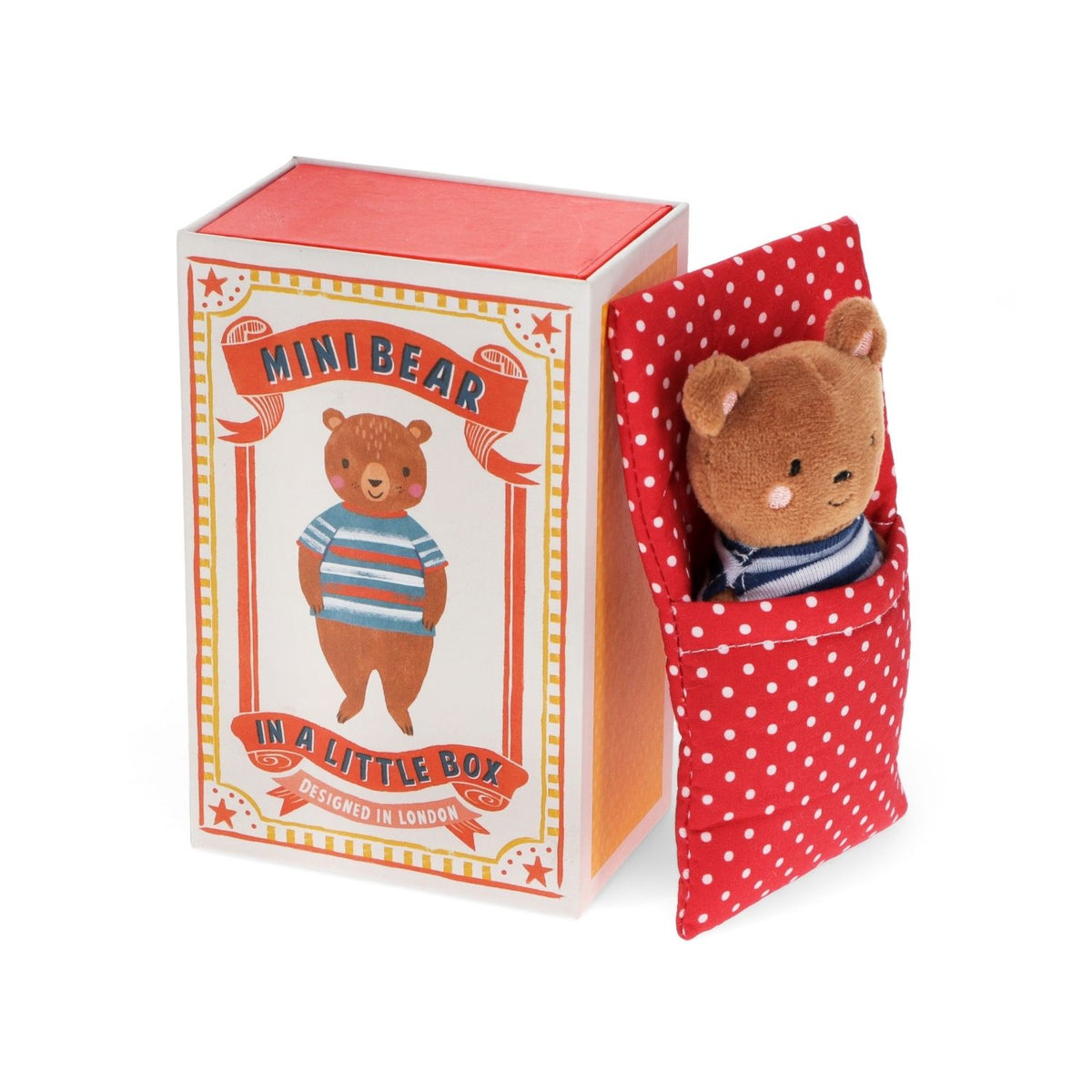 Miniature bear plush toy peeking out from a red polka dot box with packaging label.