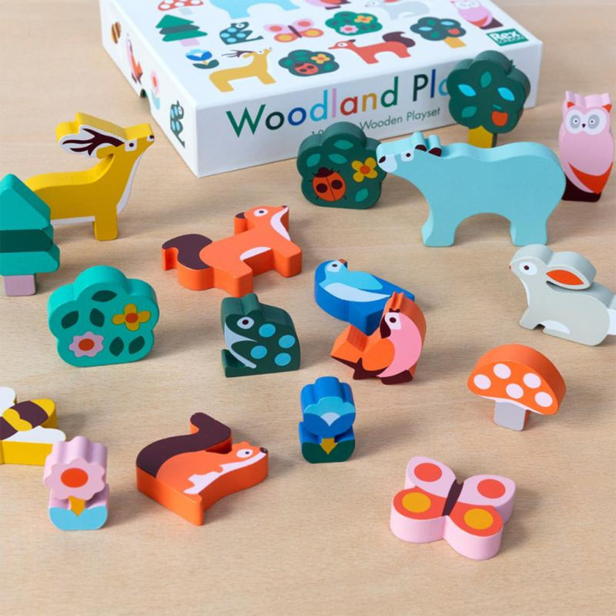 Eighteen-piece wooden play kit showing various woodland creature toys, assorted forest foliage, and wooden trees for imaginative nature-themed games.