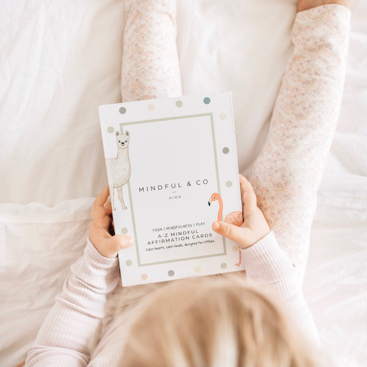 a child holding A-Z Affirmation Cards from Mindful &amp; Co