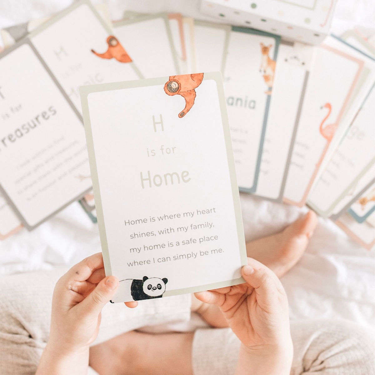 a child holding A-Z Affirmation Cards from Mindful &amp; Co