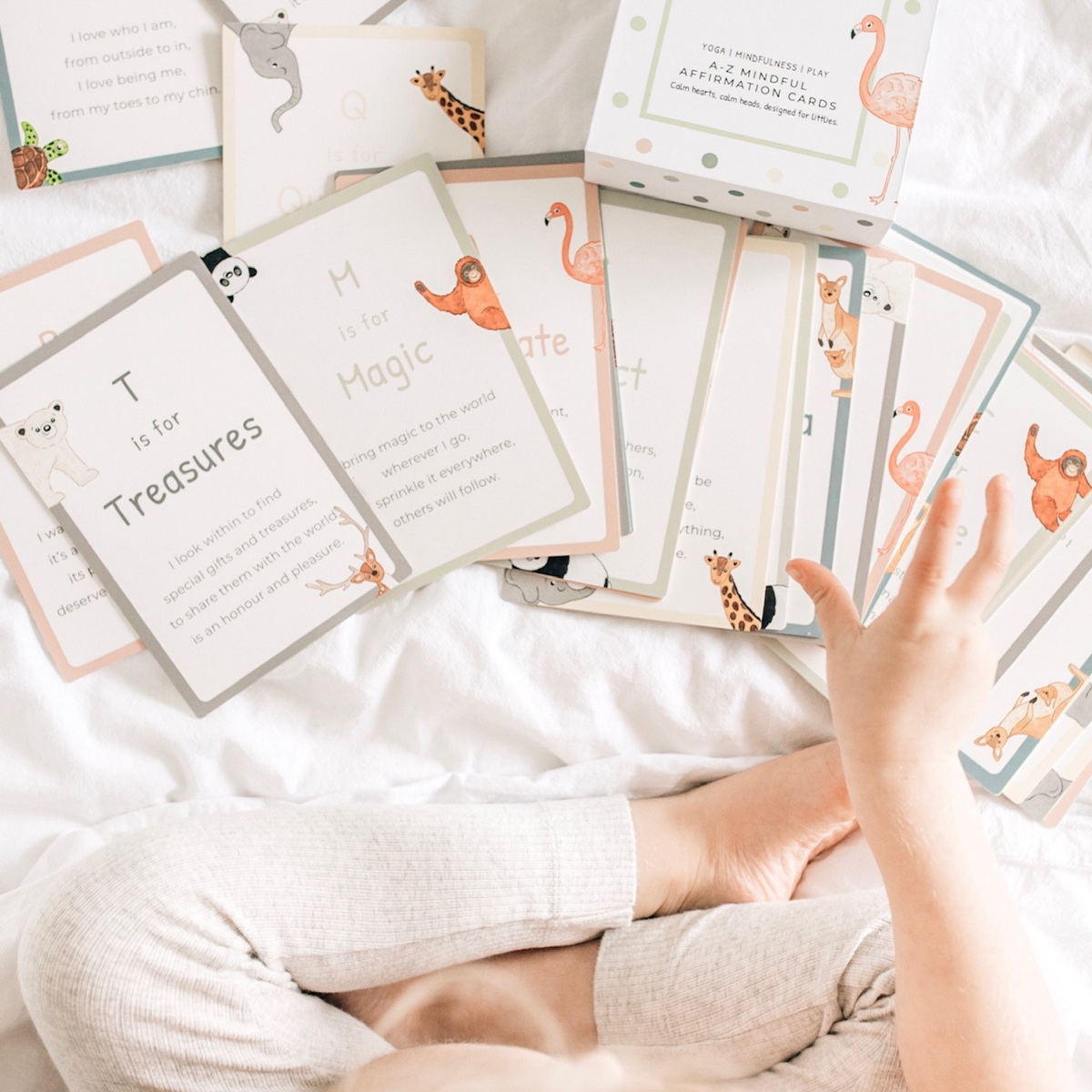 a child holding A-Z Affirmation Cards from Mindful &amp; Co