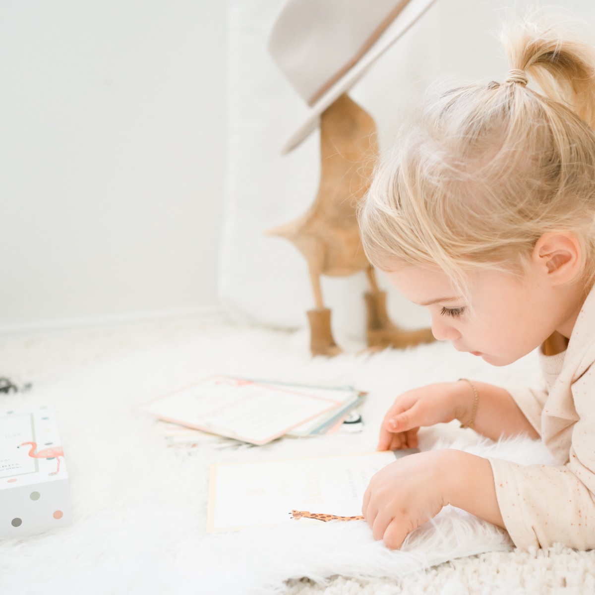 a child holding A-Z Affirmation Cards from Mindful &amp; Co