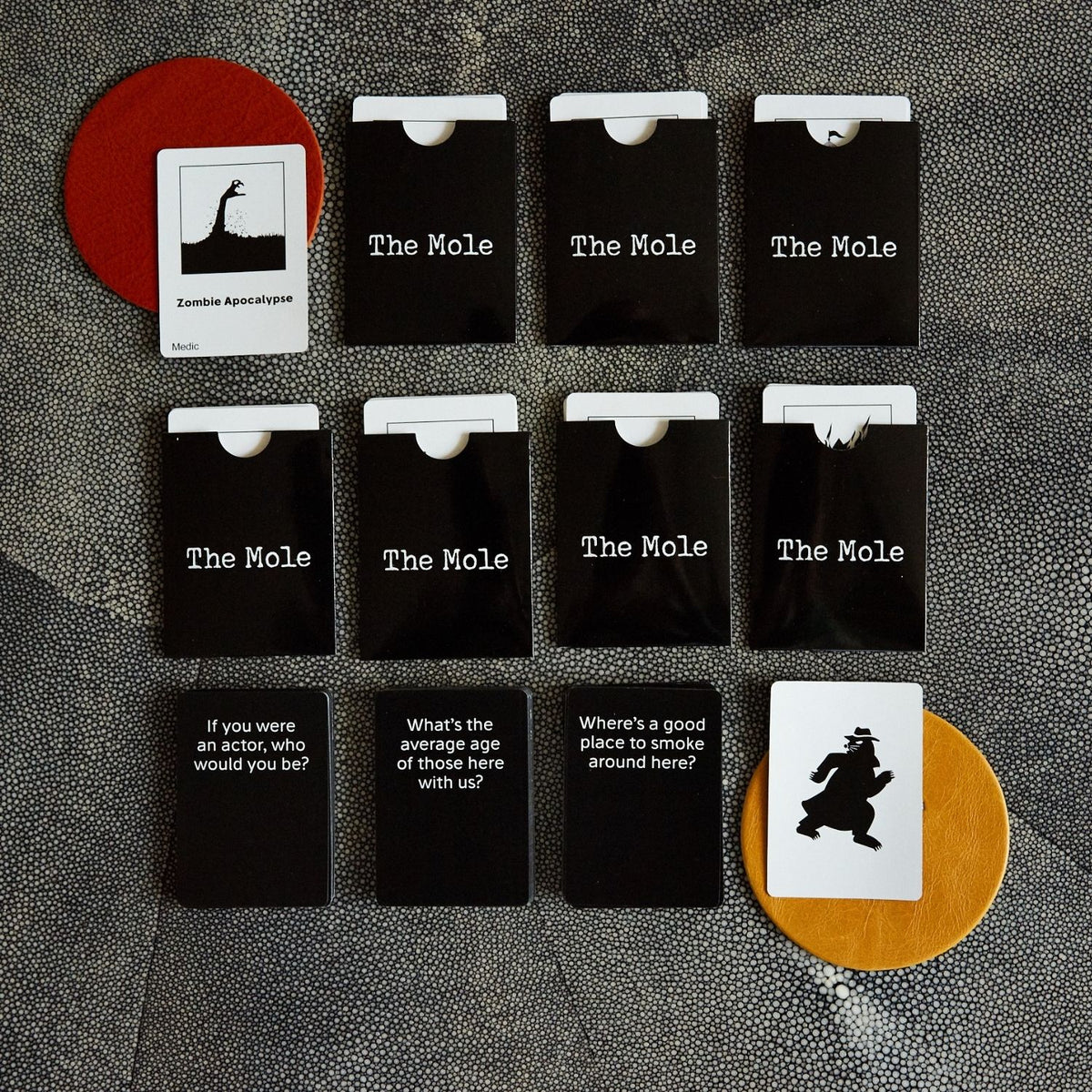 Set of 'The Mole' cards on a textured surface 
