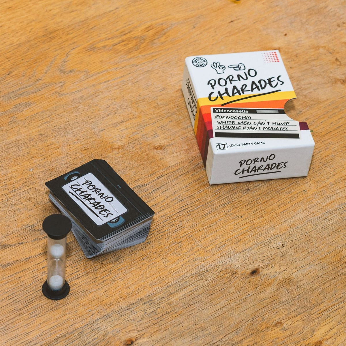 Card game packaging labeled 'Porno Charades' on a wooden surface