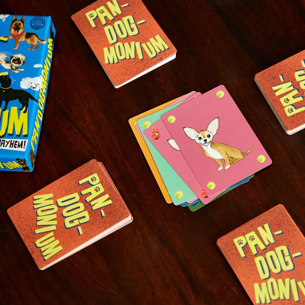 game cards with dog illustrations on a wooden surface
