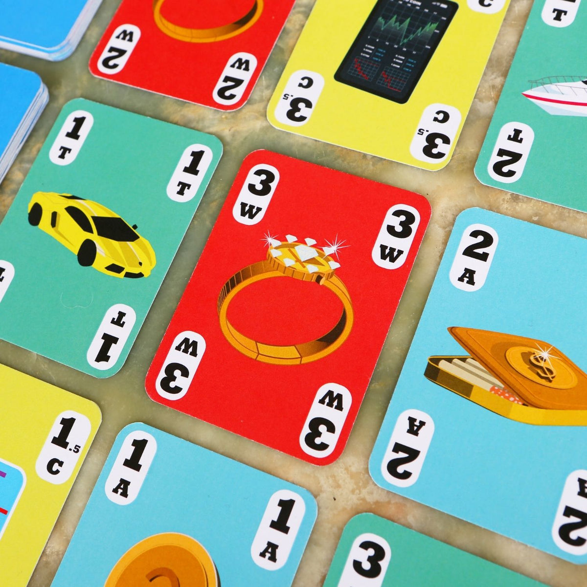 Collection of playing cards with various symbols and numbers on a wooden surface