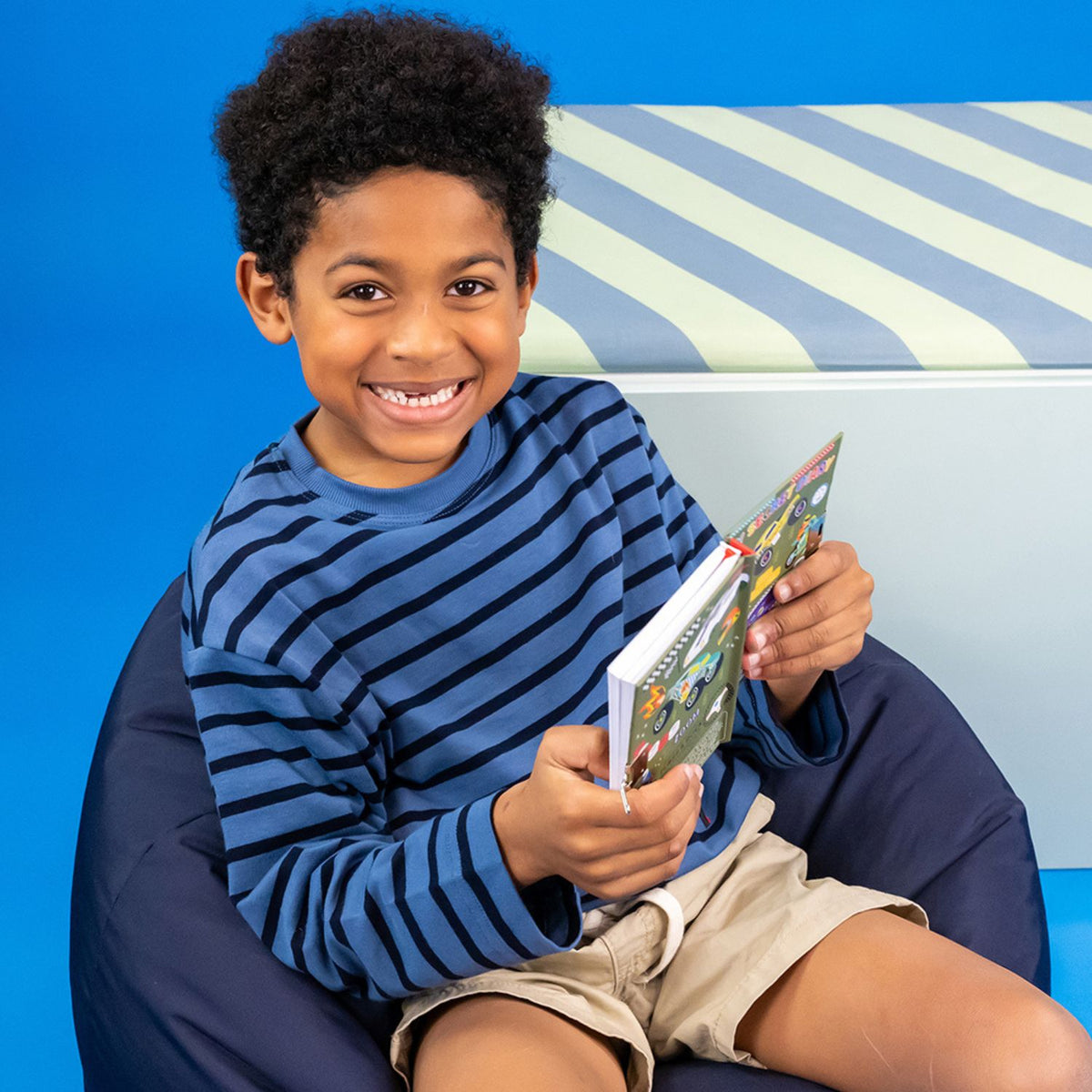 a boy sitting holding the car's diary 