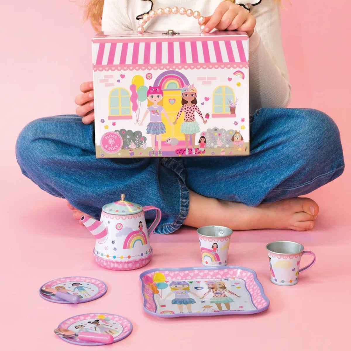 The tea set carry case being held by a child, demonstrating the portable size and how easily it can be transported for playdates or outings.