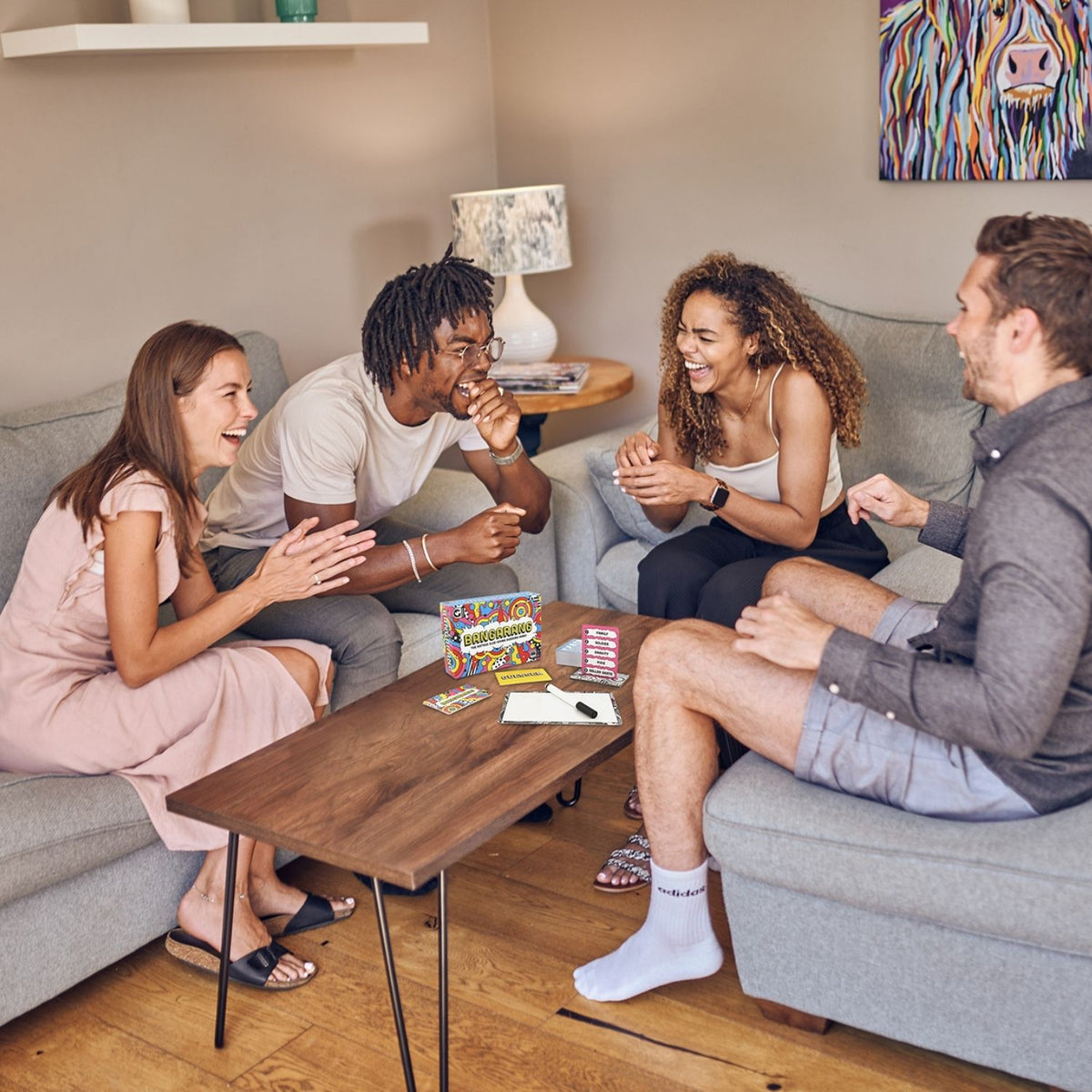 Four friends playing Bangarang together in a living room.
