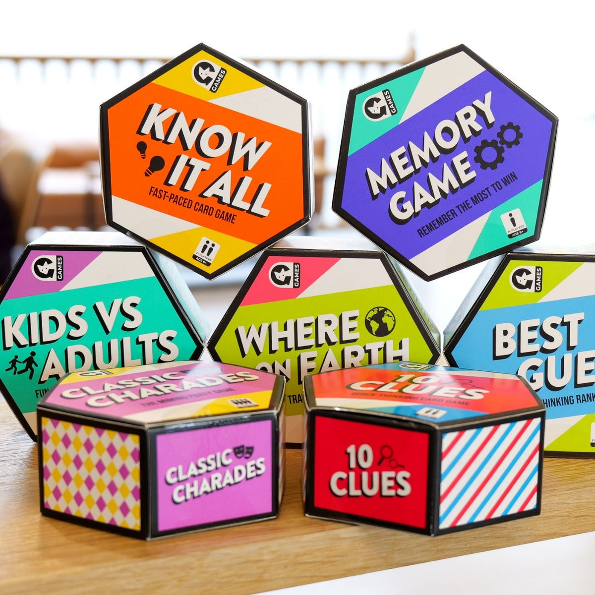 Collection of colourful Hex game boxes on a wooden surface