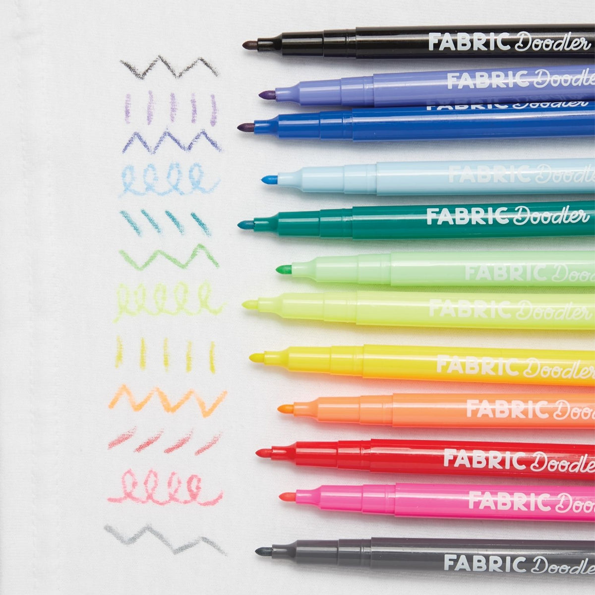 Set of Fabric Doodler markers in various colors with sample doodles o