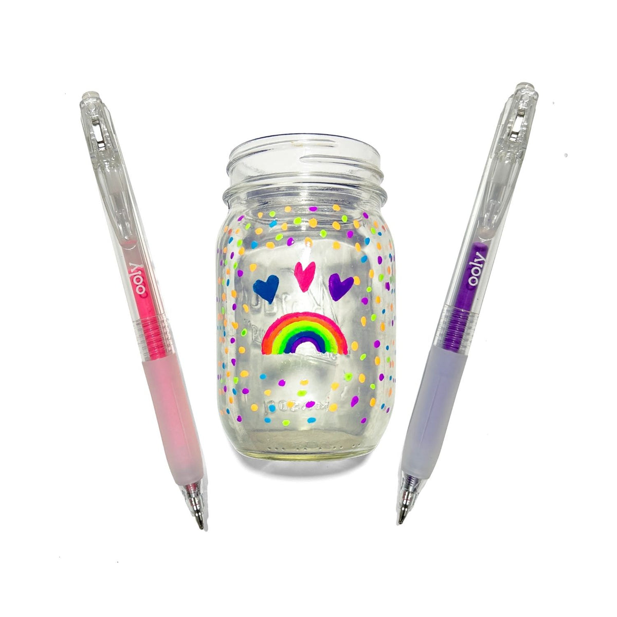 Clear jar with colorful designs and two pens 