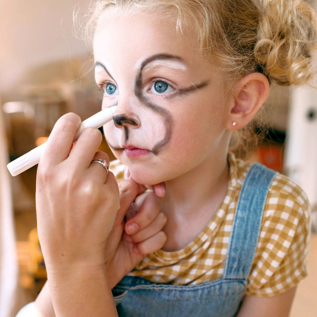 Child with face and body Doodlers being applied