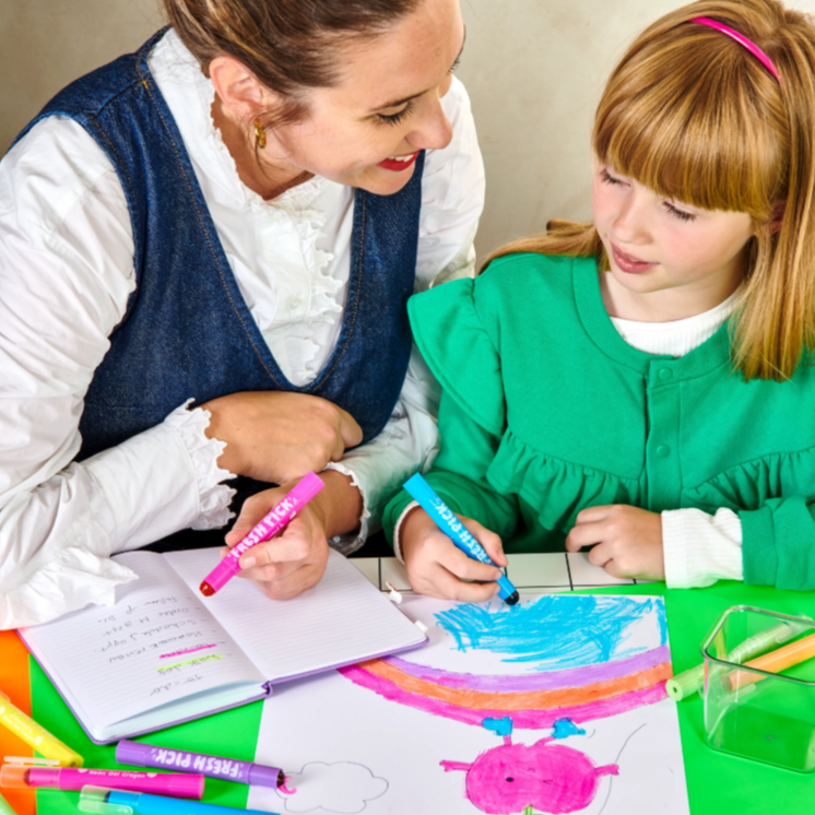 Woman and young girl coloring together with markers at a table.