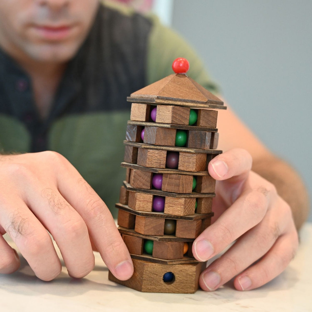 Detail Shot (Mechanism): A close-up of the smooth wooden finish and the internal track system that guides the balls through the tiers of the level four difficulty puzzle.