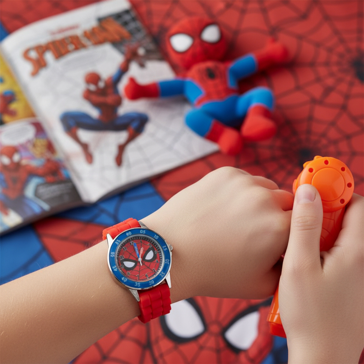 Child's hand wearing a Spider-Man watch with a toy and comic book in the background
