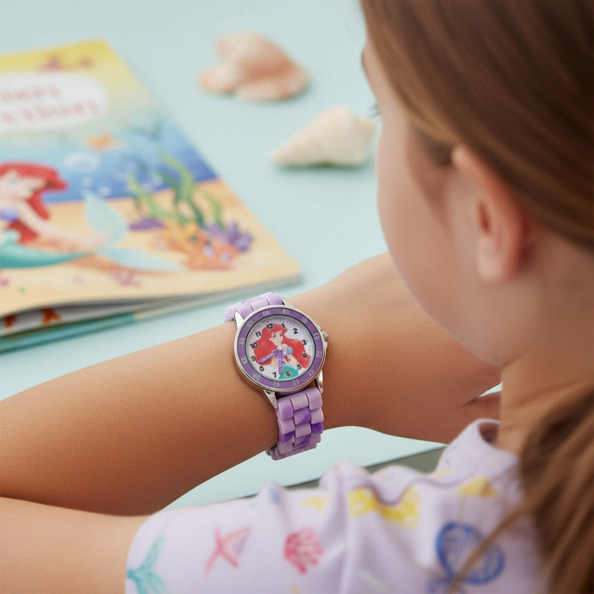 Kids wearing Disney Princess Ariel time teacher watch designed for learning to tell the time