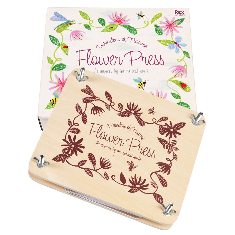 A wooden flower press kit with two plates, nuts, and bolts for pressing flowers. The packaging has a colorful floral design.